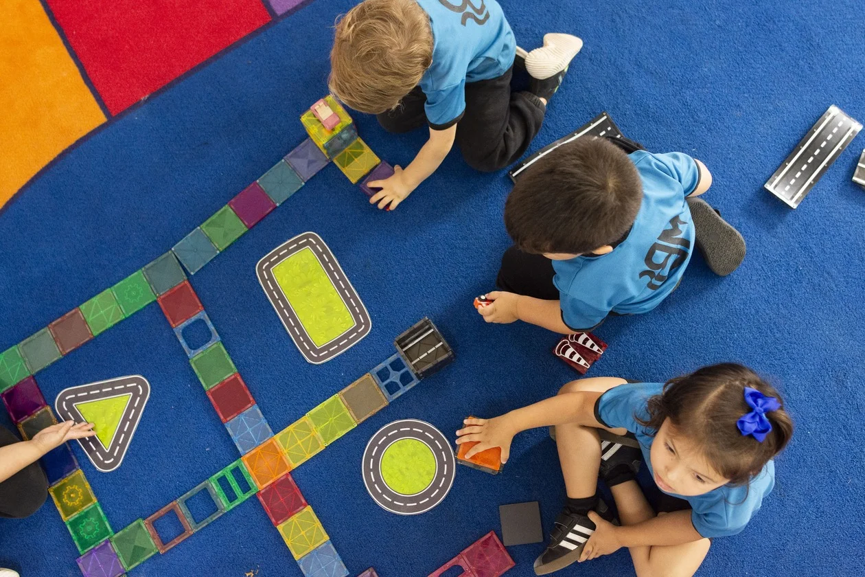MBS early childhood students working on a literacy and numeracy floor activity