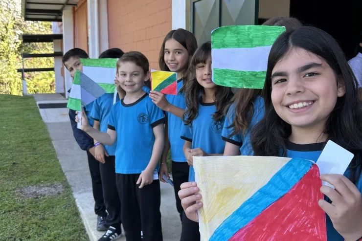 MBS early childhood students outdoors holding colorful art banners