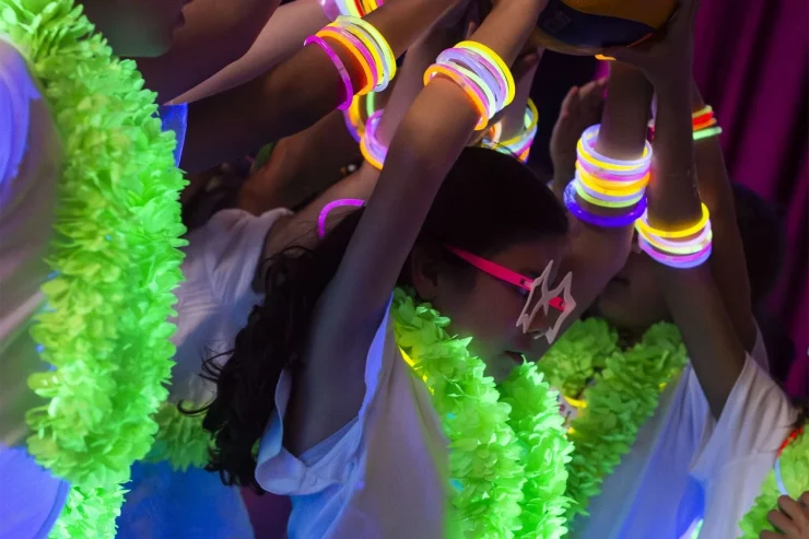 MBS students at a school spirit event with glow leis and bracelets