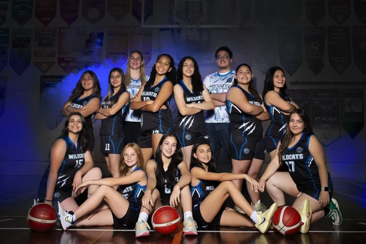 MBS Wildcats basketball team in uniform with banners in the gymnasium