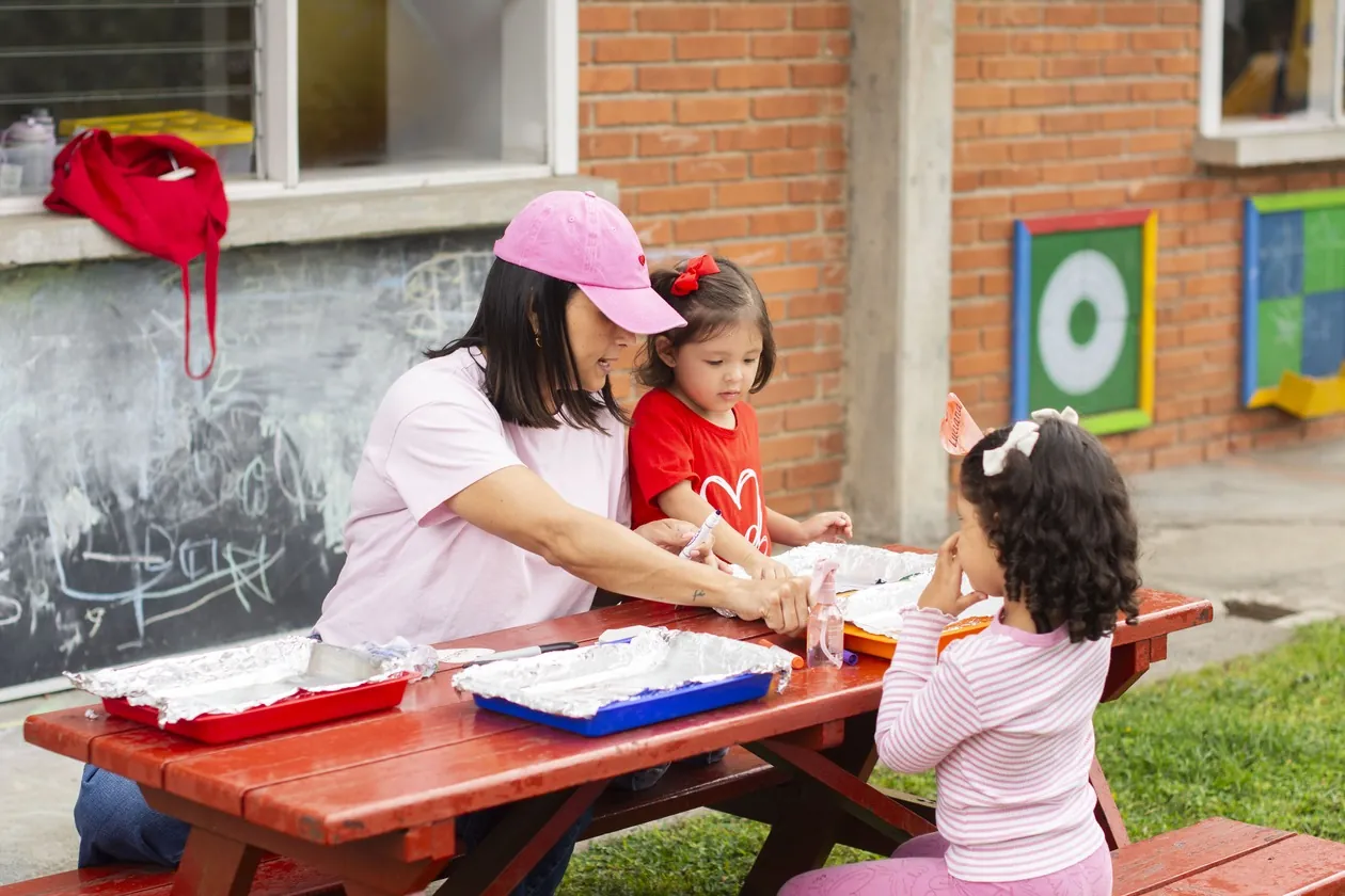 MBS teacher leading an outdoor activity with early childhood students