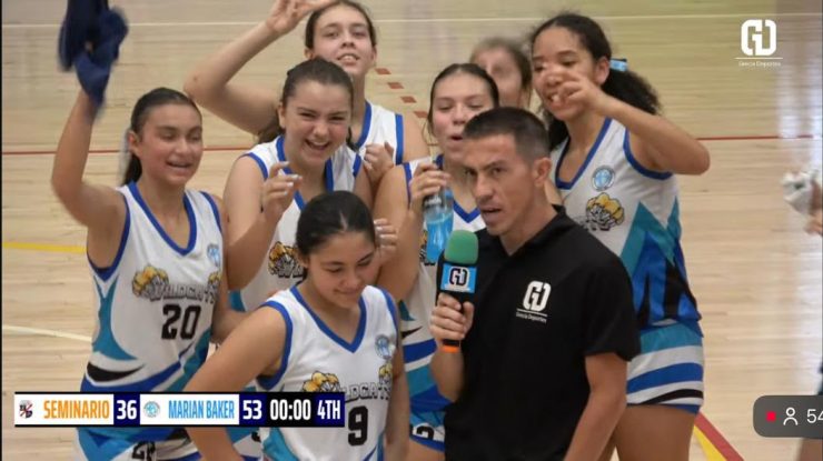 Marian Baker School Wildcats girls' basketball team celebrating with Wildcat pride