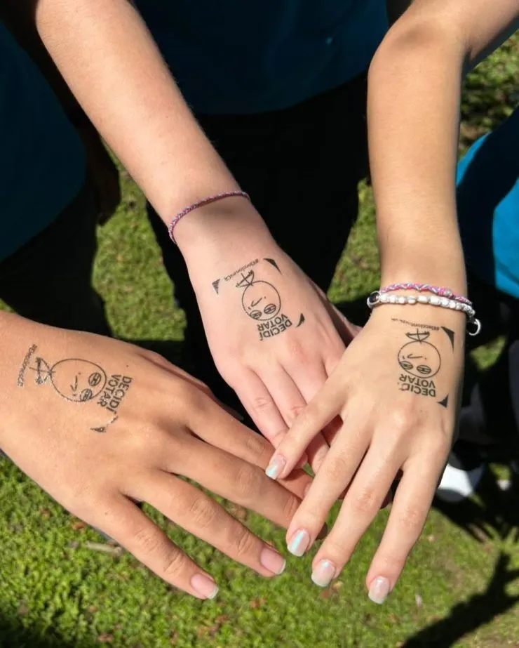 MBS students showing voting marks on their hands, symbolizing citizenship