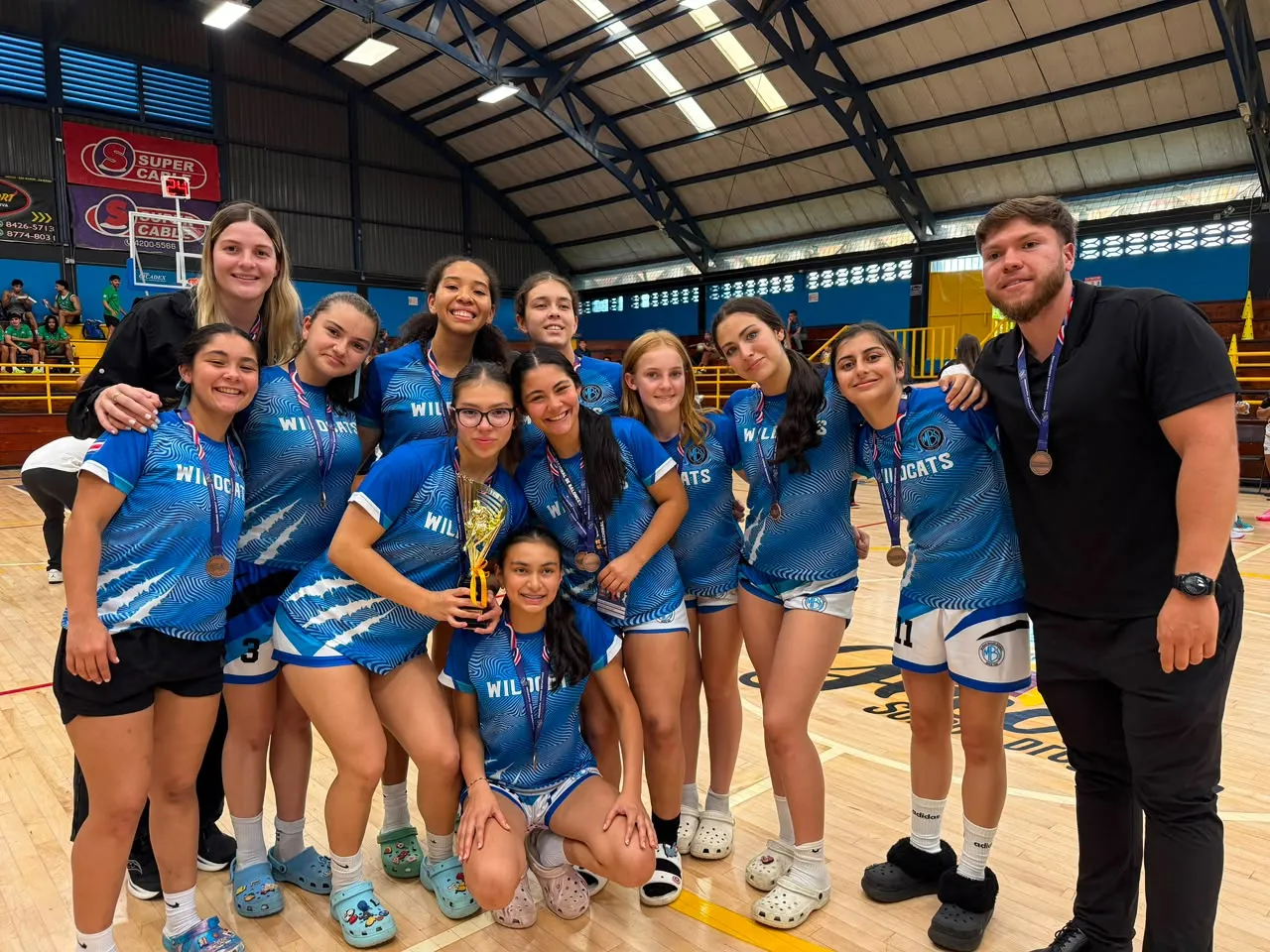 Marian Baker School girls' basketball team with their 3rd place trophy and medals at Juegos Deportivos Estudiantiles 2026