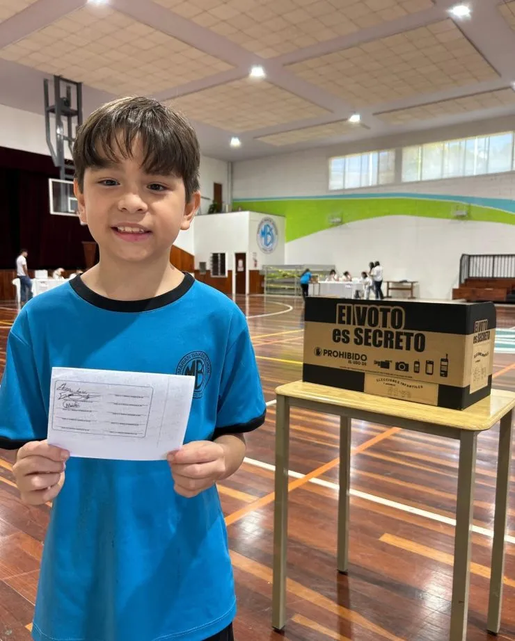 A Marian Baker School student holding a ballot on election day